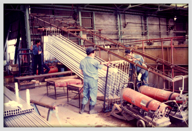 Old iron frame with coupled copper bars and tubes